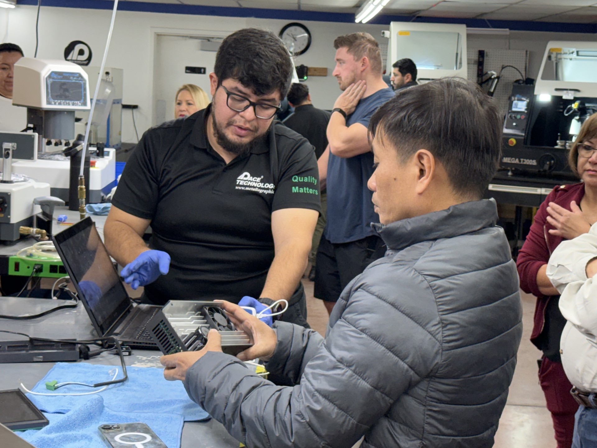 PACE applications technician giving a hands-on equipment demo to a distributor in the Tucson lab